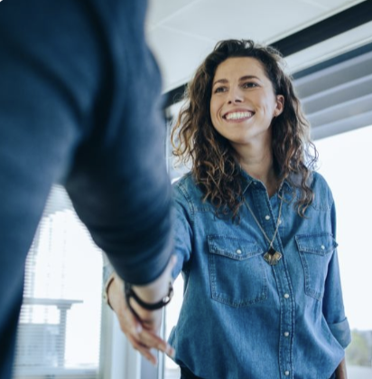 Young woman shaking mans hand